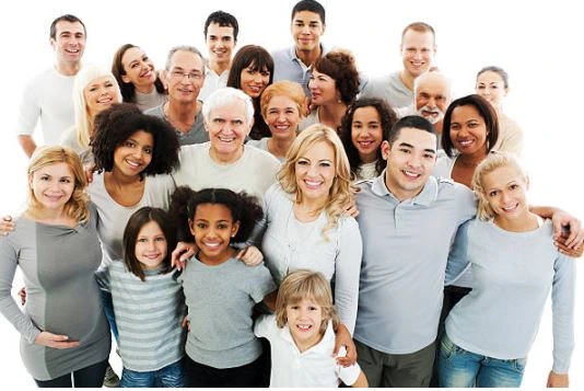 Group of diverse multigenerational people smiling and standing close together, representing family unity and community connection.
